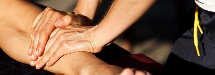 women pressing hands on forearm